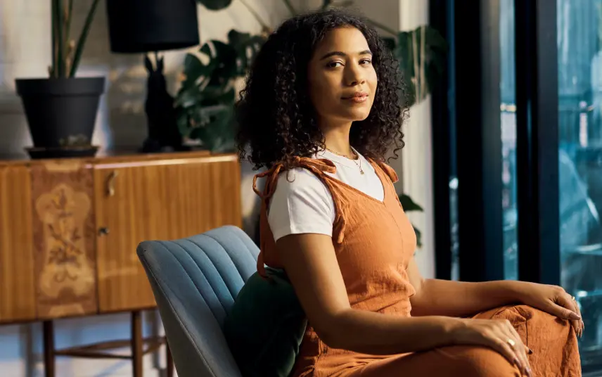 Photo of a women sitting on couch looking into the camera
