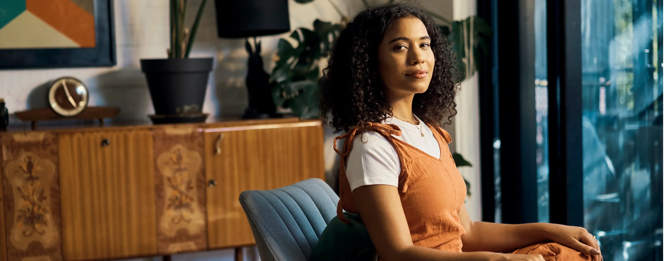 Photo of a women sitting on couch looking into the camera
